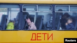 Children evacuated from the Russian-controlled city of Kherson wait on a bus heading to Crimea in late October 2022.