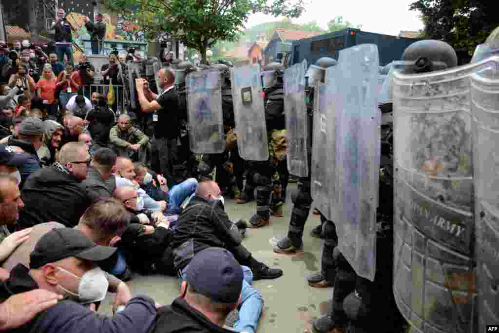 Kosovo Serbs face off with riot police outside the municipal headquarters in Zvecan on May 29. The protesters gathered to demand the removal of recently elected ethnic Albanian mayors.&nbsp; &nbsp;