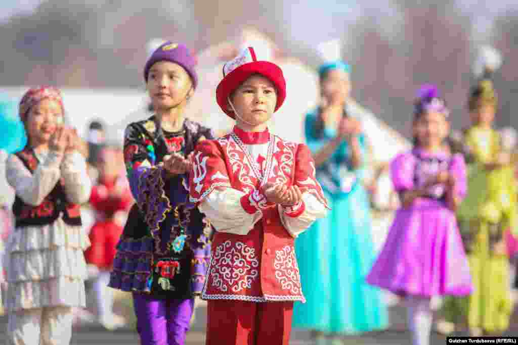 Young children wearing traditional costumes take part in celebrations at Ala-Too Square in Bishkek.