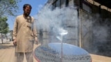 Local blacksmith Ghulam Abbas tests a solar stove that he built at his workshop in Kabul on May 8. The parabola-shaped solar heaters have grown in popularity in Afghanistan as the country is in the grip of a chronic energy crisis.
