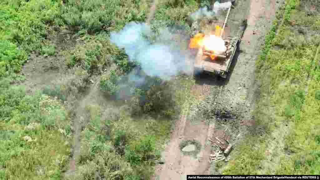 A photo released by the Ukrainian military claims to show a Russian tank on fire after a drone dropped a bomb on it, northwest of Bakhmut, on July 15. RFE/RL has no way to verify battlefield accounts.&nbsp;