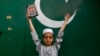 A boy holds the Koran during an anti-Sweden demonstration in Lahore, Pakistan, on July 9.