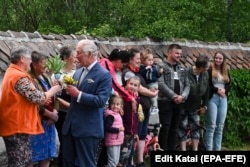 King Charles III (third from left) receives flowers from locals as he arrives at his estate in Valea Zalanului in eastern Transylvania on June 2.