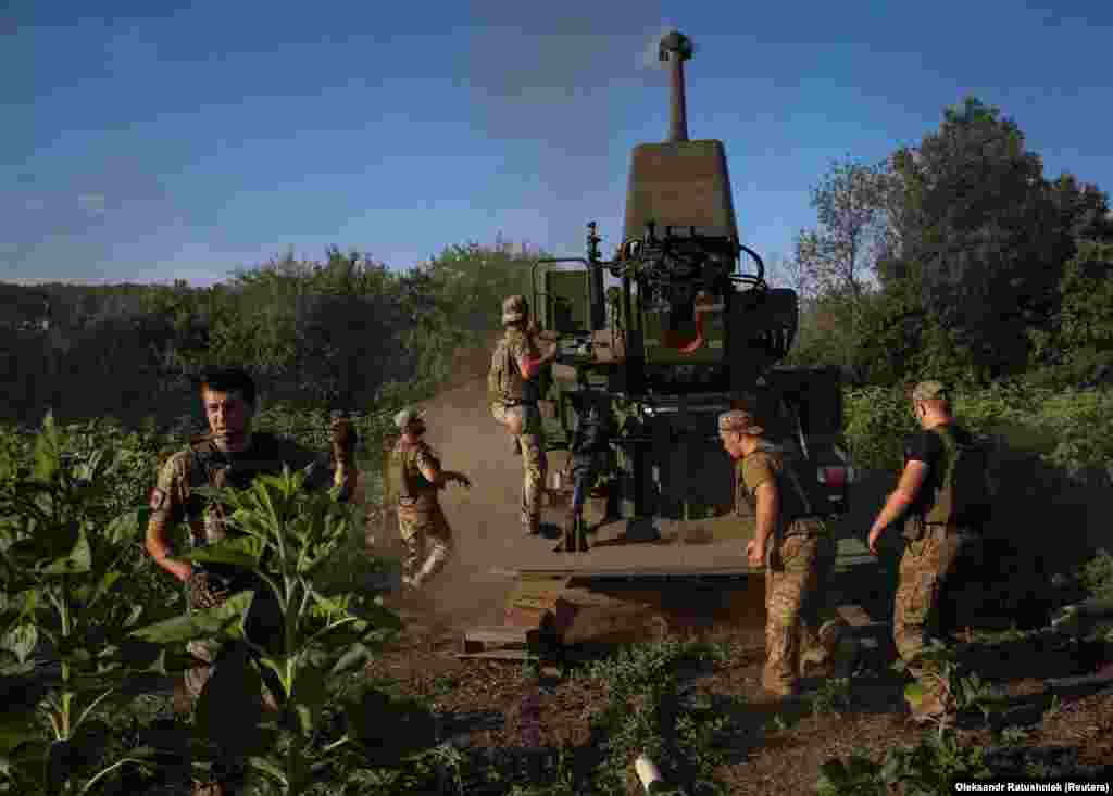 Ukrainian servicemen prepare to fire a self-propelled howitzer in an undisclosed location in eastern Ukraine. &nbsp;