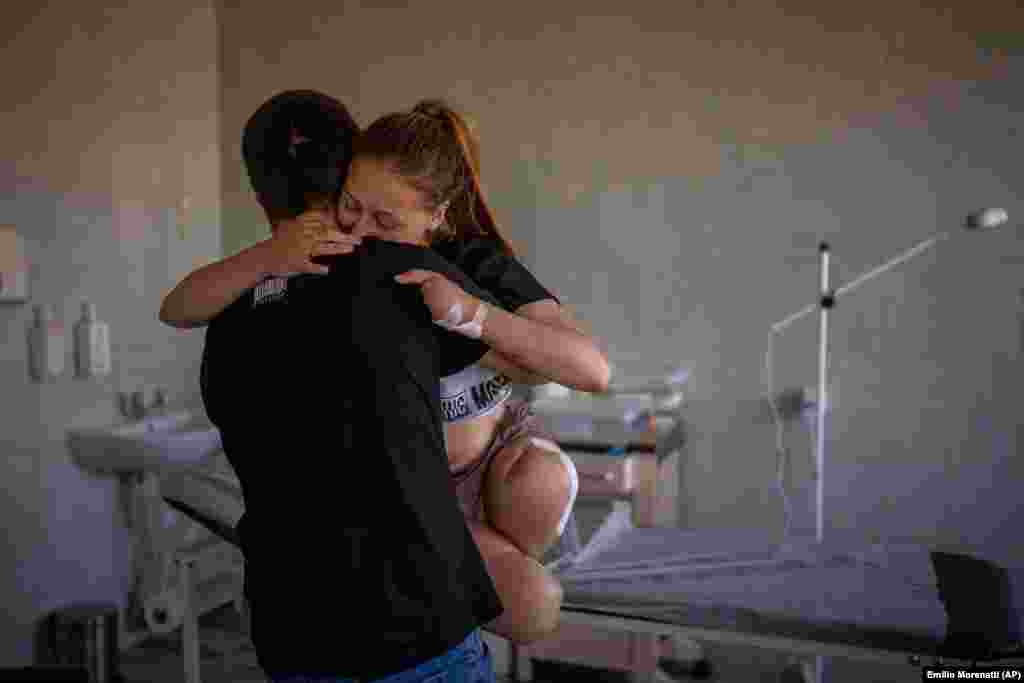 Viktor carries his wife, Oksana Balandina, at a hospital in Lviv, Ukraine, on May 14, 2022. The couple married while Oksana was in the hospital, and Viktor carried her like this for their first dance. World Press Photo Europe Honorable Mention: Emilio Morenatti, AP &nbsp;