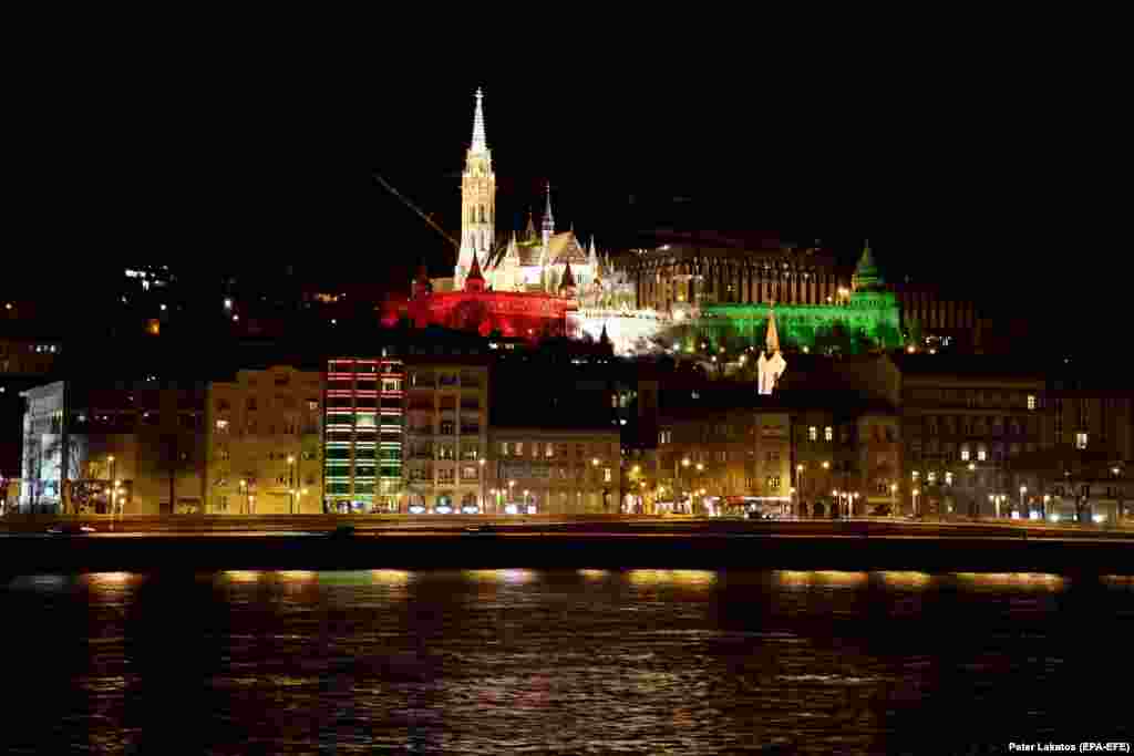 The Fisherman&#39;s Bastion at Buda Castle is illuminated with Hungary&#39;s national colors to commemorate the 175th anniversary of the outbreak of the 1848 revolution and war of independence against Habsburg rule in Budapest.