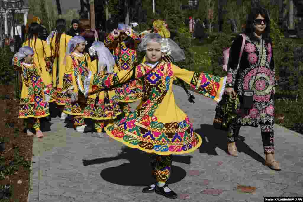 A Tajik girl spins in her colorful traditional dress in&nbsp;Dushanbe.