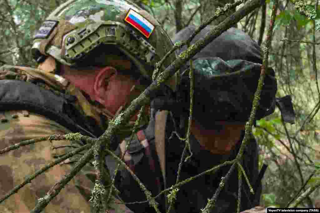 A fighter wearing a Russian flag with another soldier during the joint exercises.&nbsp; The Kremlin weighed in on July 20, with spokesman Dmitry Peskov telling reporters that Poland&#39;s relocation of troops to its eastern border was &quot;a cause for concern,&quot; adding that what he called &quot;the aggressiveness of Poland is a reality.&quot;&nbsp;
