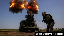 A Ukrainian soldier fires a self-propelled howitzer toward Russian troops at a position near the city of Bakhmut on July 5.