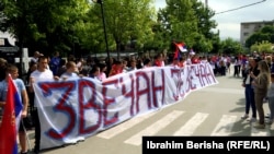 Parents of primary-school children in Zvecan hold a banner reading "Zvecan Is Forever" during a June 5 demonstration.