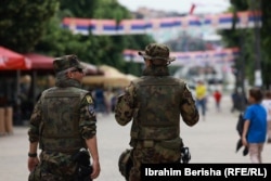 Two KFOR troops patrol the road leading from heavily Albanian South Mitrovica to predominantly Serb North Mitrovica.