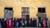 Afghan women wait to receive food rations distributed by a humanitarian aid group in Kabul, Afghanistan, late last month. 