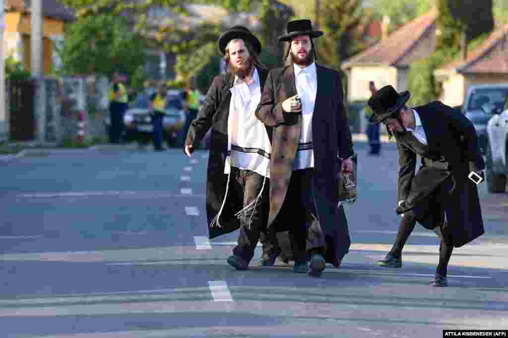 Arriving by bus, private plane, and helicopter, Hasidic Jewish pilgrims walk through the Hungarian village of Bodrogkeresztur on April 23 to worship at the tomb of the late Rabbi Yeshaya Steiner. &nbsp; &nbsp; 