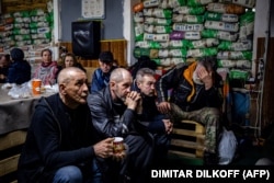 Ukrainians watch a movie on TV at a humanitarian aid center in Bakhmut on February 27.