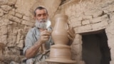 In a dusty and hot area of Kandahar, Nazar Mohammad creates a clay pot using the same traditional technique as his ancestors. He is one of the many craftsmen hoping to keep Afghanistan&#39;s rich artistic heritage of Kolali pottery -- known for its unique blue and green glazes -- alive for future generations.