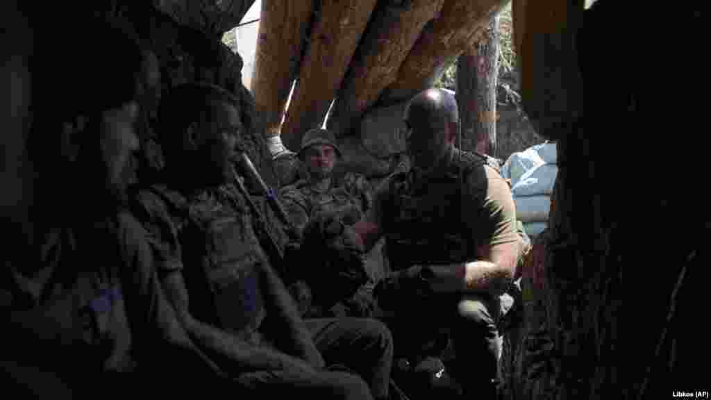 Ukrainian soldiers rest in a trench that was previously held by Moscow&#39;s forces. &nbsp;