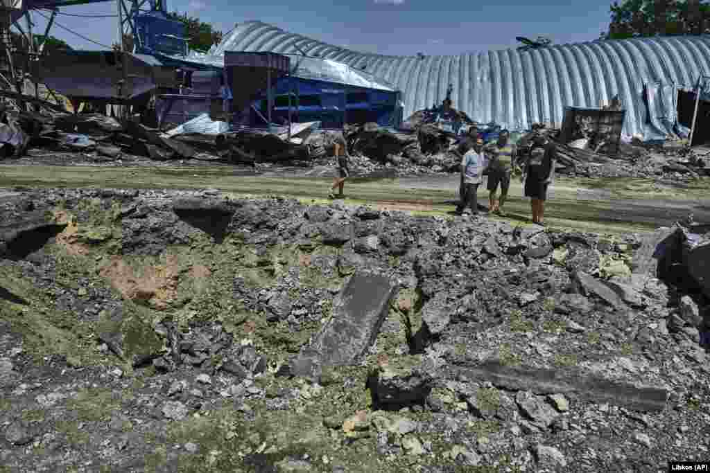 People walk next to a destroyed agricultural storage building.&nbsp; Kiper said Russia launched Kalibr-type cruise missiles from vessels in the Black Sea that targeted the facilities in Odesa.