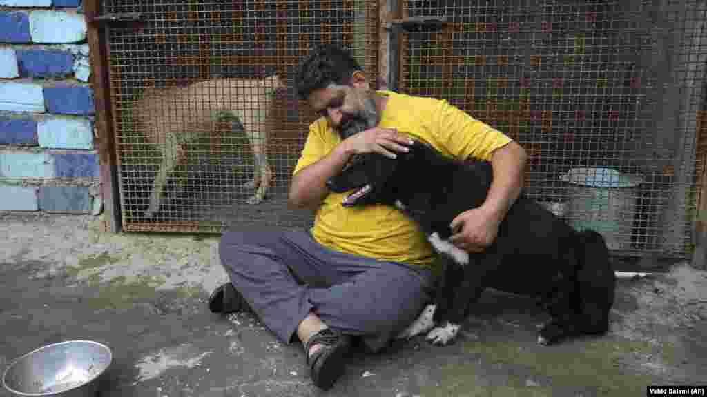 Iranian cleric Sayed Mahdi Tabatabaei cuddles an impaired dog at his shelter outside the city of Qom, 125 kilometers south of the capital, Tehran, on May 21. Tabatabaei has amassed over 80,000&nbsp;followers&nbsp;on Instagram as he shares his heartbreaking stories of the abused and neglected dogs that he has treated at his shelter.&nbsp;&nbsp; 