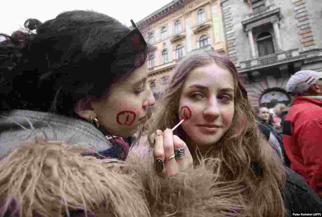 Women get creative with their face paintings as they participate in the demonstration.