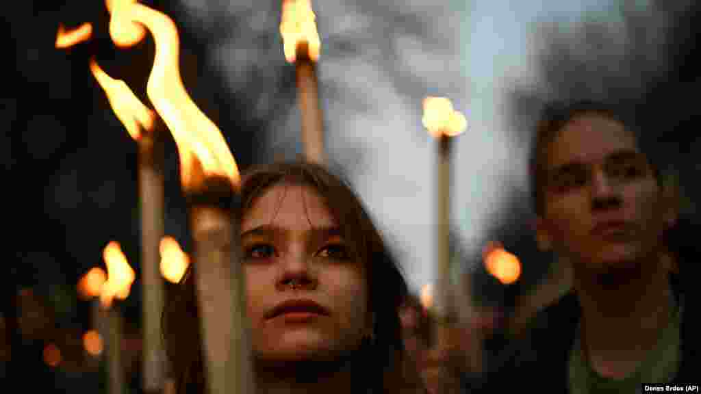 A young woman holds a torch during the march.