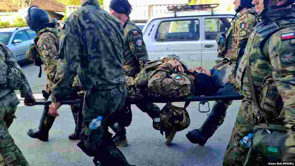 An injured KFOR soldier is removed from the clashes. U.S. and EU envoys have expressed concern about the intensifying violence.&nbsp; &nbsp;
