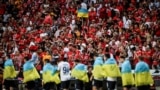 Dynamo Kyiv players enter the pitch wearing Ukrainian national flags during the UEFA Champions League playoff second leg soccer match against SL Benfica in Portugal on August 23, 2022.