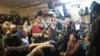 One of the few photos from inside the basement during captivity taken by an individual who managed to hide his phone shows dozens of people crowded in a room shoulder-to-shoulder.
