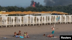 Smoke and flames rise after explosions at a Russian military airbase in Novofedorivka, Crimea, in August.