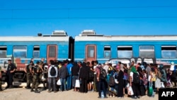 Migrants wait to board a train to Serbia near the town of Gevgelija. (file photo)