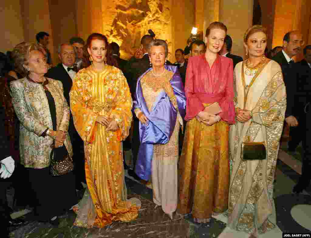 Bernadette Chirac, the wife of French President Jacques Chirac (left), Princess Lalla Salma of Morocco (second from left), Children&#39;s Foundation President Anne-Aymone Giscard d&#39;Estaing (center), Princess Mathilde of Belgium (second from right), and former Iranian Empress Farah Pahlavi (right) pose as they arrive at the Palace of Versailles in France to attend a charity gala in December 2003.