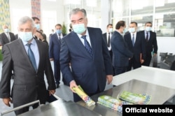 Rustam Kholiqov (left), the former head of Tajik Air, is seen with President Emomali Rahmon at an official event in September 2020.