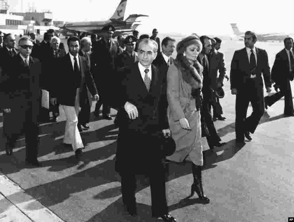 The shah and Empress Farah make their way to board a plane at Mehrabad Airport in Tehran as they flee the country amid the tumult of the Iranian Revolution in January 1979.