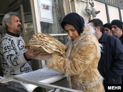 Iran - Iranians queue at a bakery in Tehran to buy traditional bread.