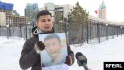 Baibolat Kunbolat protests in front of the Chinese Embassy in Nur-Sultan in February 2020 holding a poster of his brother who has been imprisoned in Xinjiang.